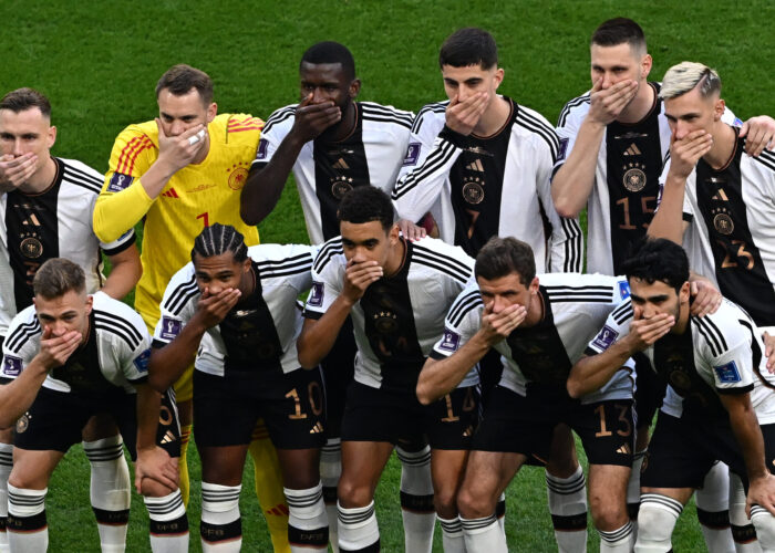 (Top, L-R) Germany's defender #03 David Raum, goalkeeper #01 Manuel Neuer, defender #02 Antonio Ruediger, midfielder #07 Kai Havertz, defender #15 Niklas Suele and defender #23 Nico Schlotterbeck and (Bottom, L-R) midfielder #06 Joshua Kimmich, forward #10 Serge Gnabry, midfielder #14 Jamal Musiala, forward #13 Thomas Mueller and midfielder #21 Ilkay Gundogan cover their mouths as they pose for the team picture ahead of the Qatar 2022 World Cup Group E football match between Germany and Japan at the Khalifa International Stadium in Doha on November 23, 2022. (Photo by Anne-Christine POUJOULAT / AFP)